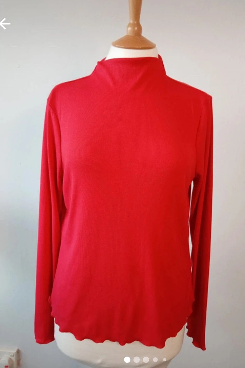 Sweaty Betty red ribbed long sleeve top with mock neck and lettuce-edge hem.