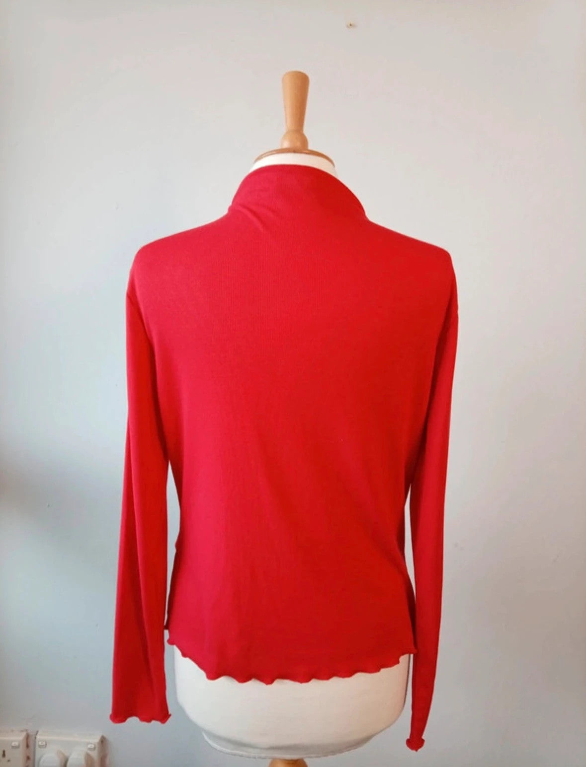 Sweaty Betty red ribbed long sleeve top with mock neck and lettuce-edge hem.