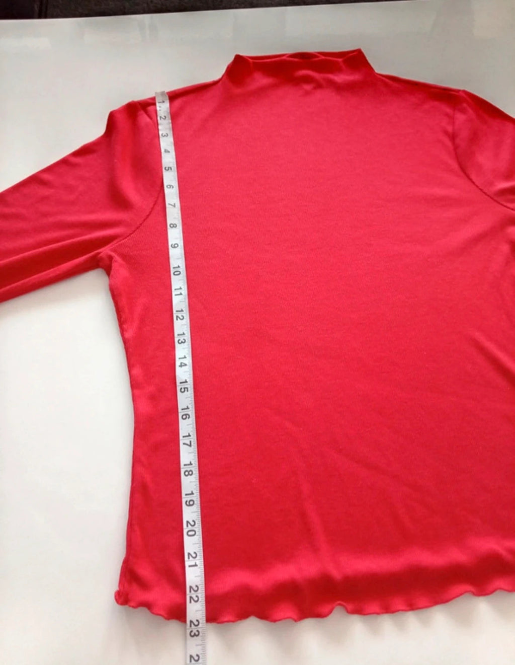 Sweaty Betty red ribbed long sleeve top with mock neck and lettuce-edge hem.