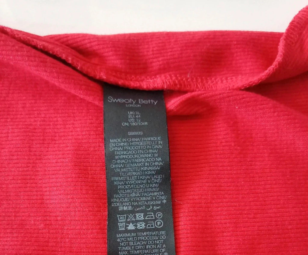 Sweaty Betty red ribbed long sleeve top with mock neck and lettuce-edge hem.