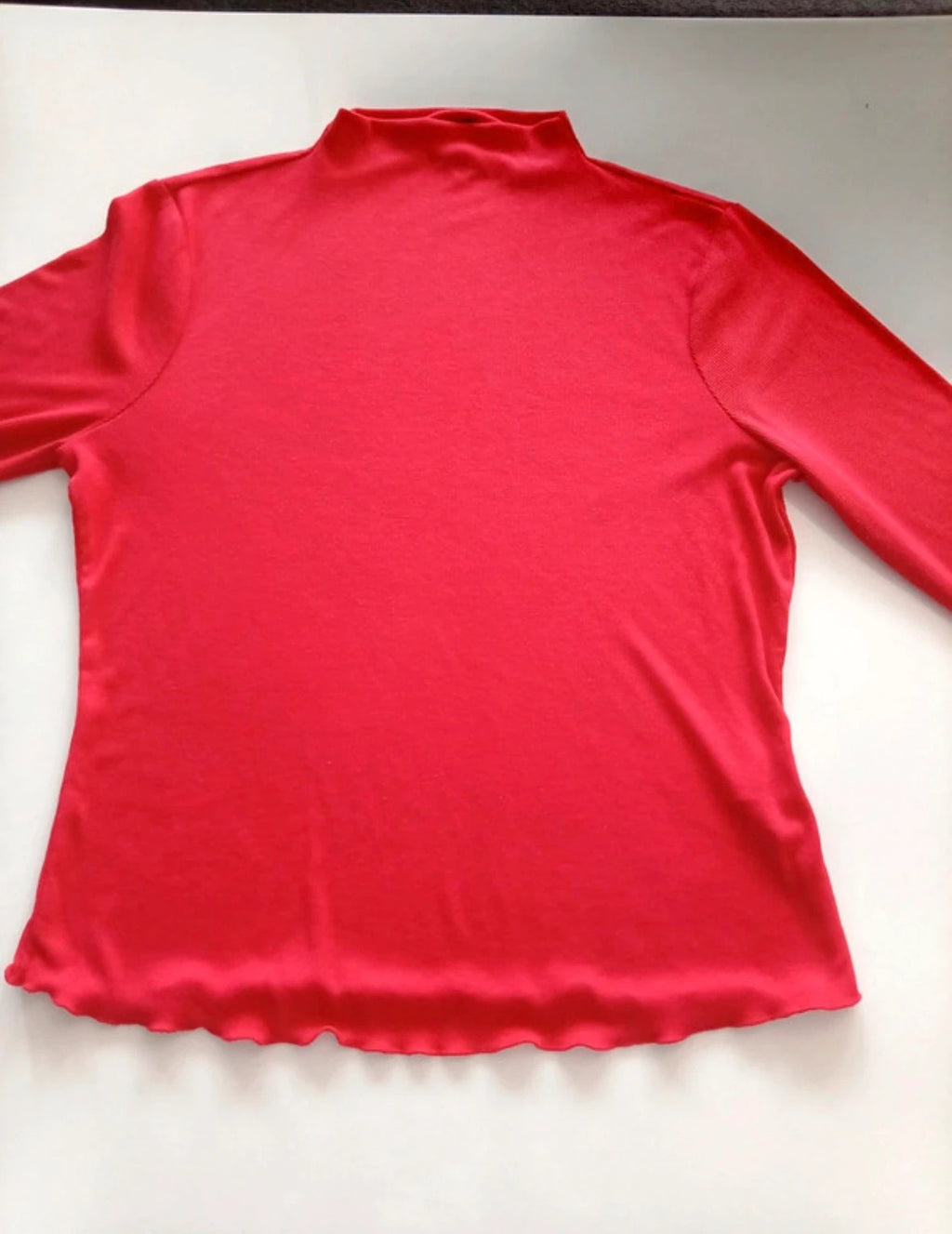 Sweaty Betty red ribbed long sleeve top with mock neck and lettuce-edge hem.