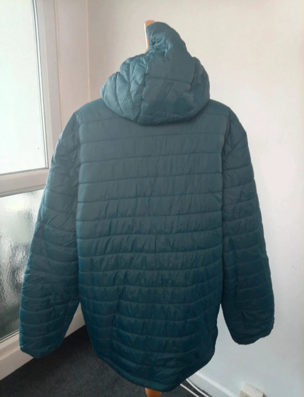 Peter Storm teal blue puffer jacket with hood and contrasting orange lining.