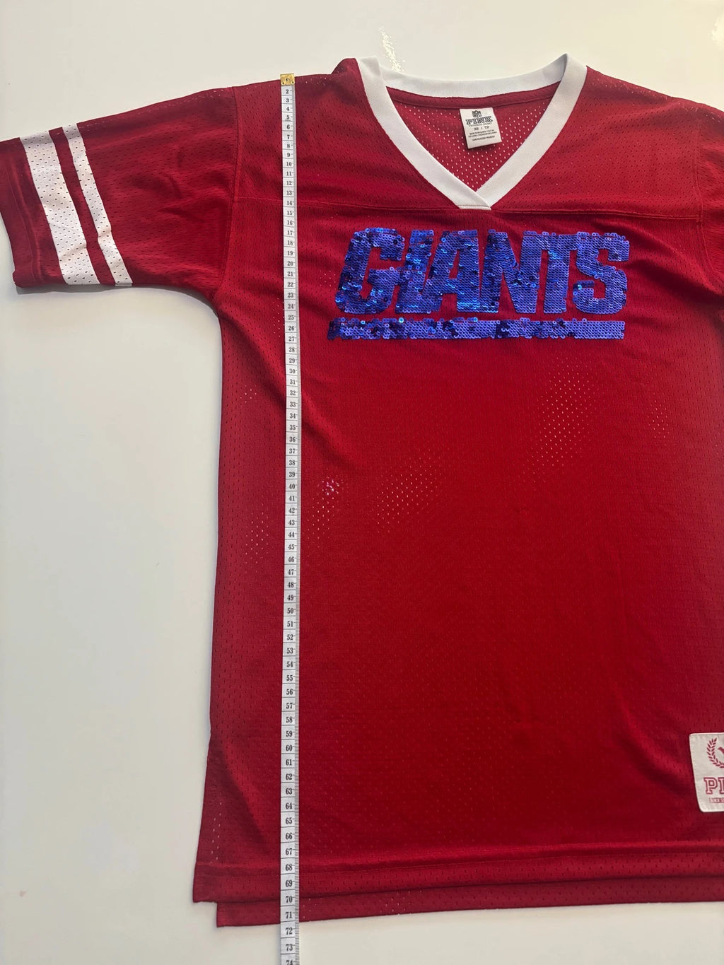 Victoria's Secret PINK burgundy NFL jersey with blue sequined GIANTS lettering and white trim.