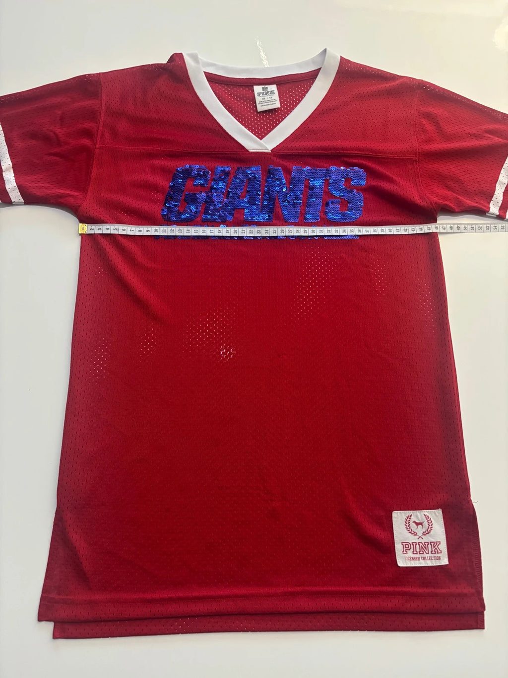 Victoria's Secret PINK burgundy NFL jersey with blue sequined GIANTS lettering and white trim.