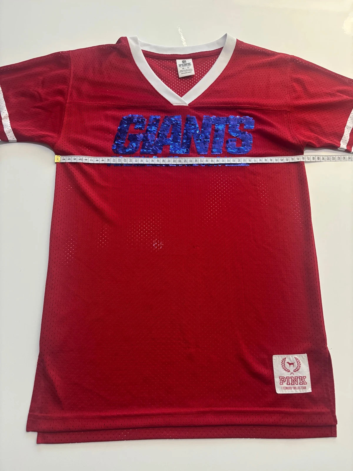 Victoria's Secret PINK burgundy NFL jersey with blue sequined GIANTS lettering and white trim.