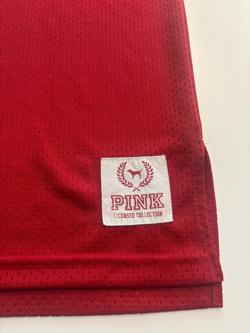 Victoria's Secret PINK burgundy NFL jersey with blue sequined GIANTS lettering and white trim.