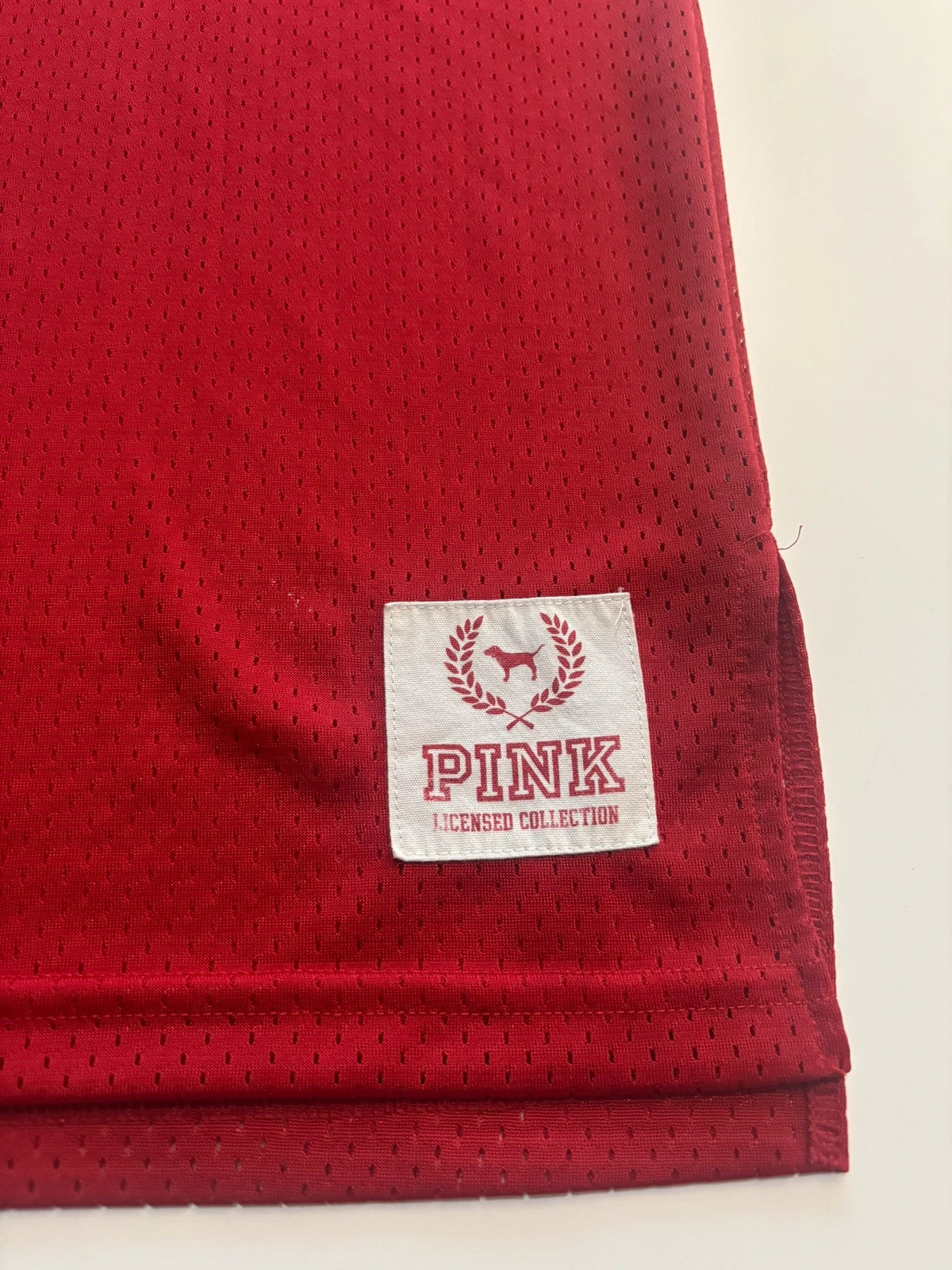Victoria's Secret PINK burgundy NFL jersey with blue sequined GIANTS lettering and white trim.