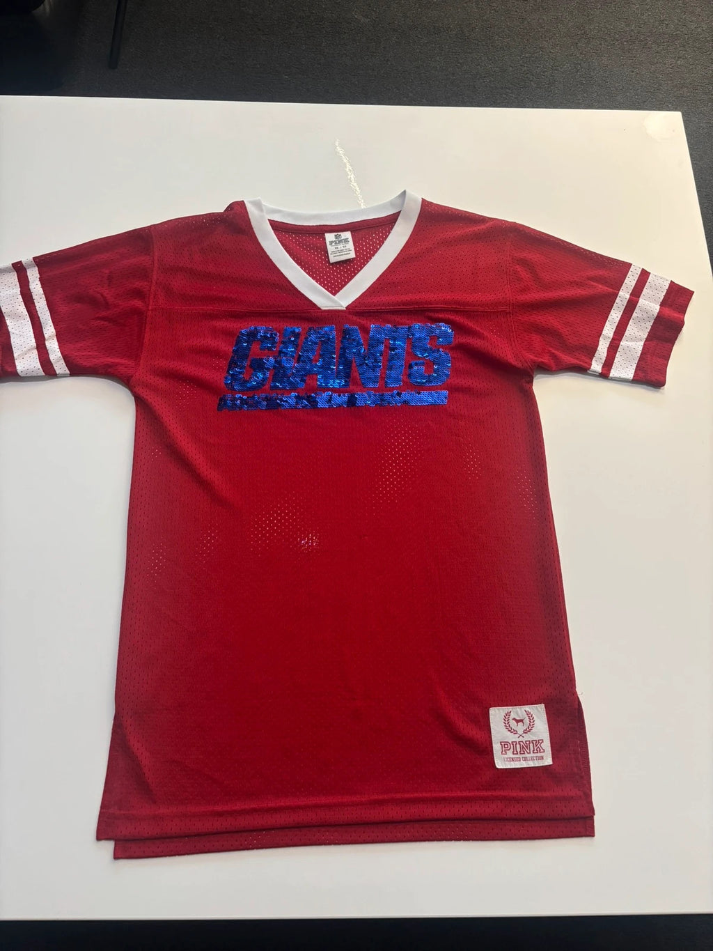 Victoria's Secret PINK burgundy NFL jersey with blue sequined GIANTS lettering and white trim.