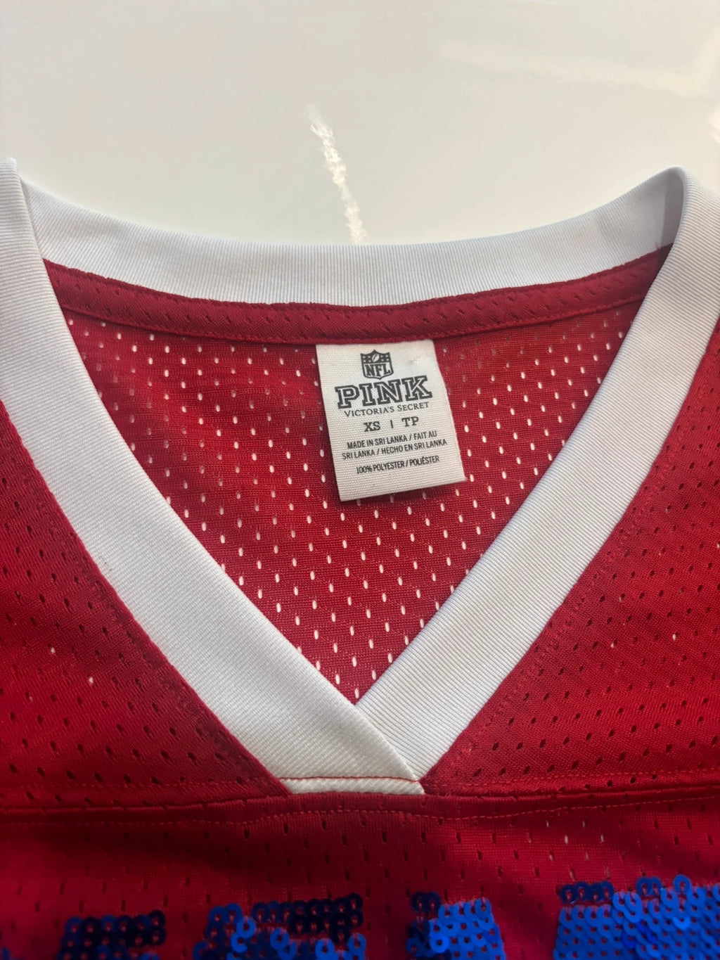 Victoria's Secret PINK burgundy NFL jersey with blue sequined GIANTS lettering and white trim.