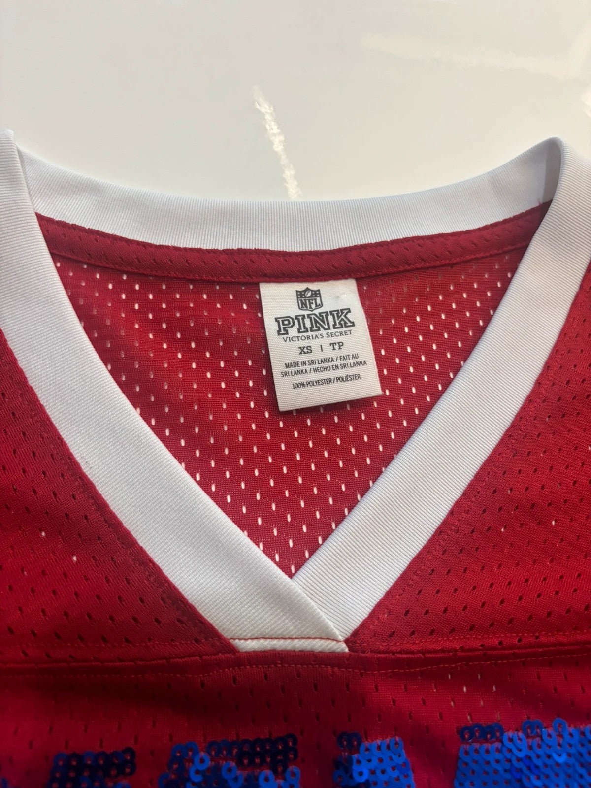 Victoria's Secret PINK burgundy NFL jersey with blue sequined GIANTS lettering and white trim.